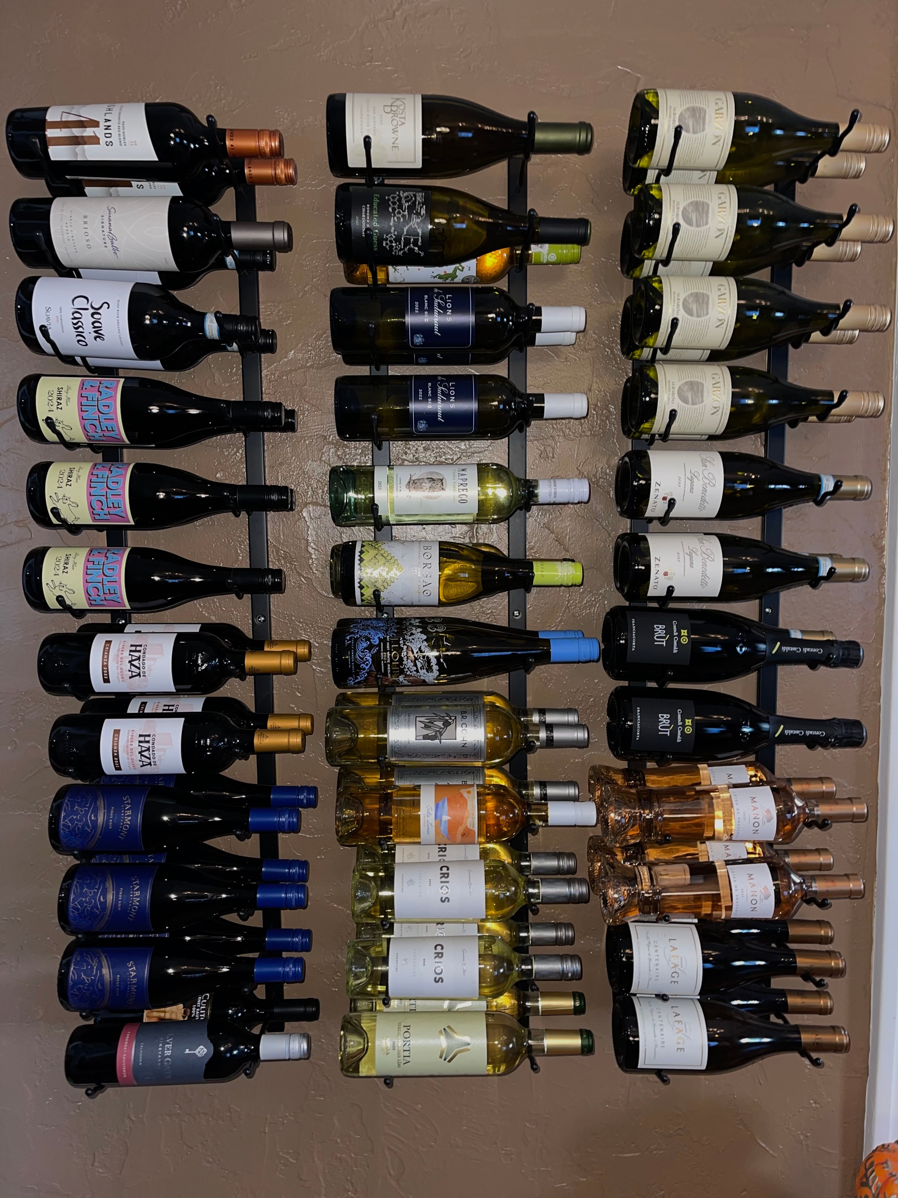 Wine bottle wall display at The Social Cellar