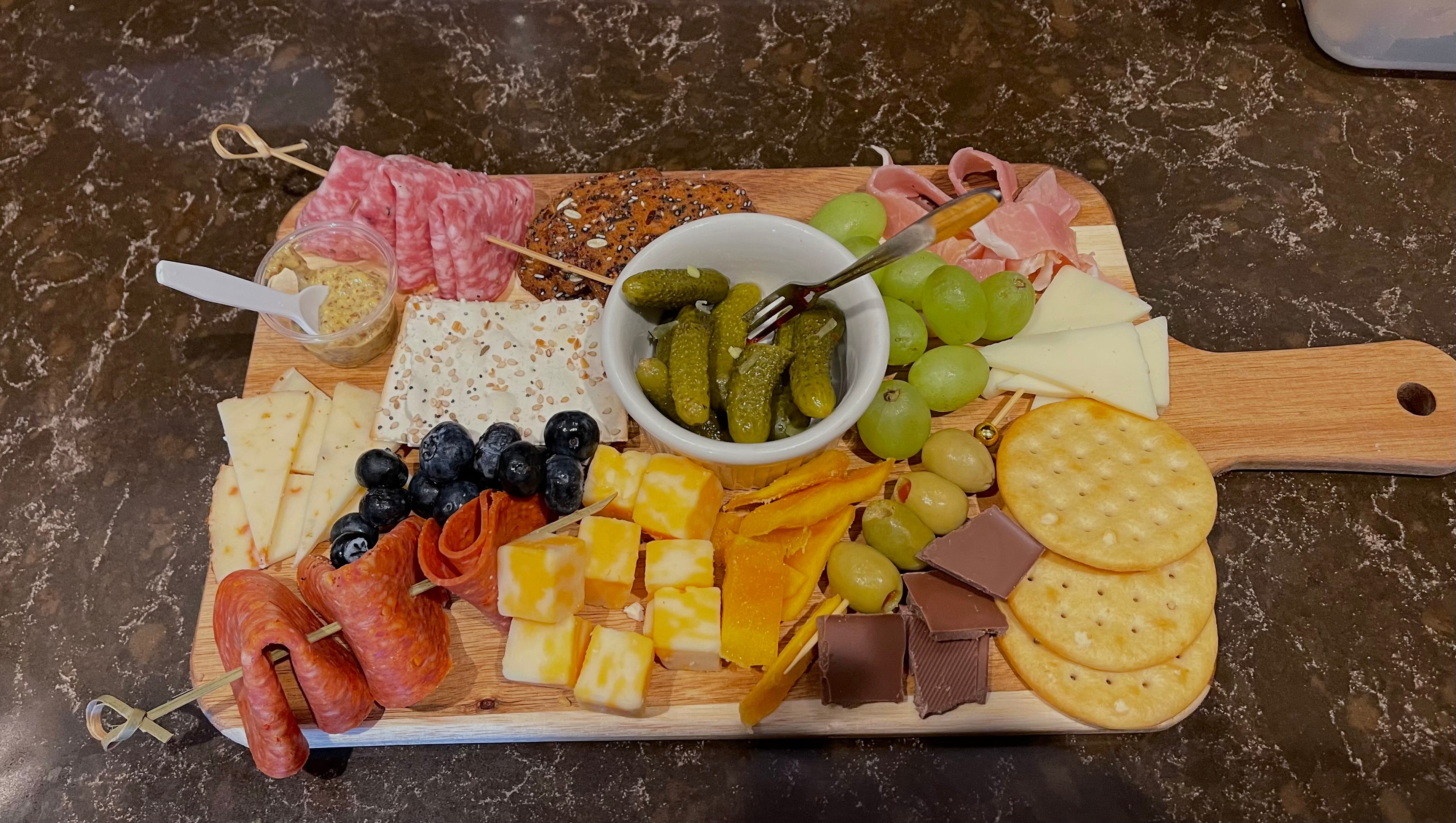 Charcuterie board with meats, cheeses, fruit and crackers at The Social Cellar
