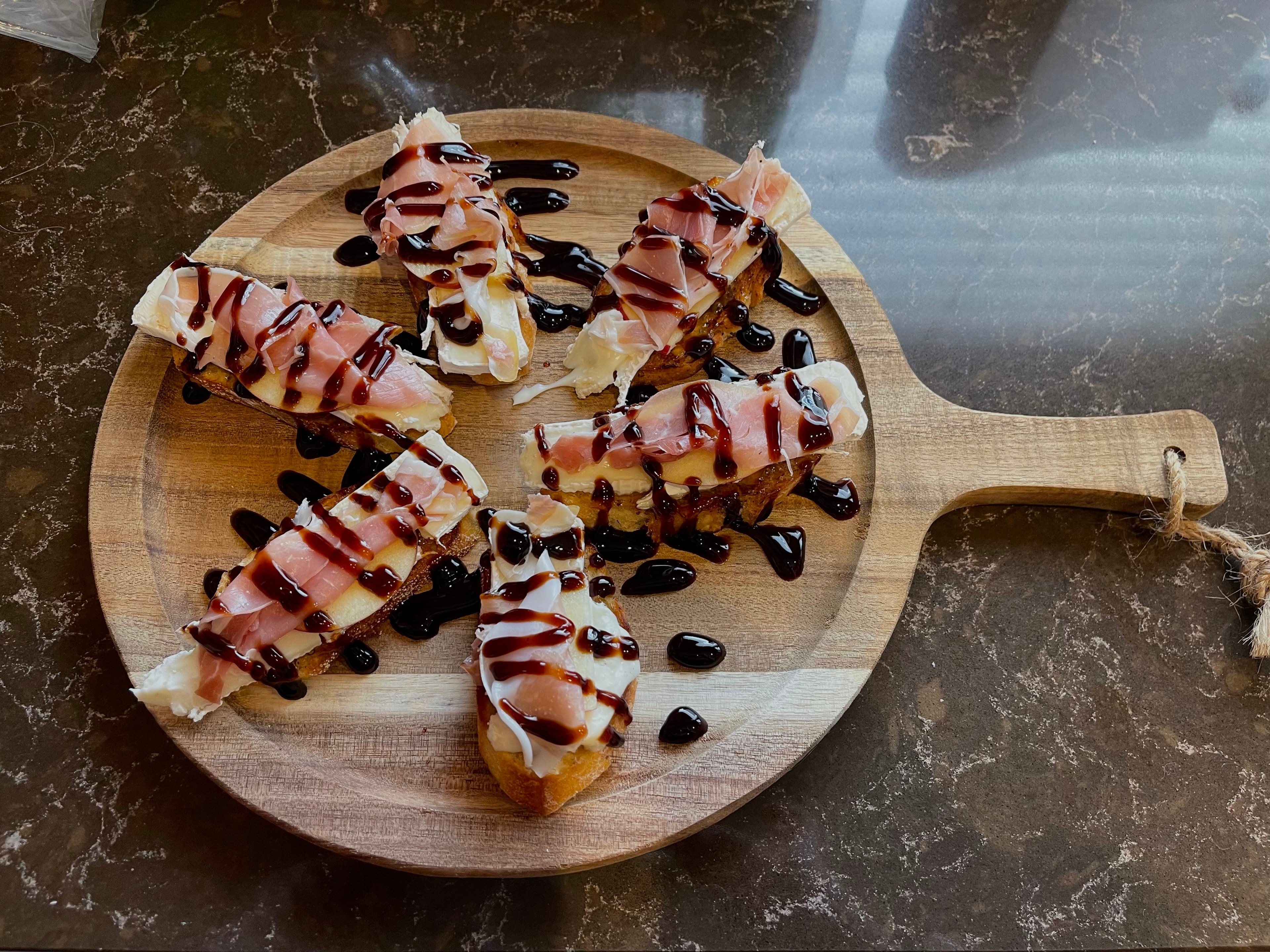 Prosciutto and brie crostini with balsamic drizzle at The Social Cellar